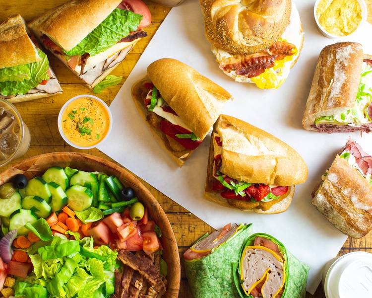 Sandwiches, salad bowl, wrap and iced coffee as shown on the deli's delivery listing
